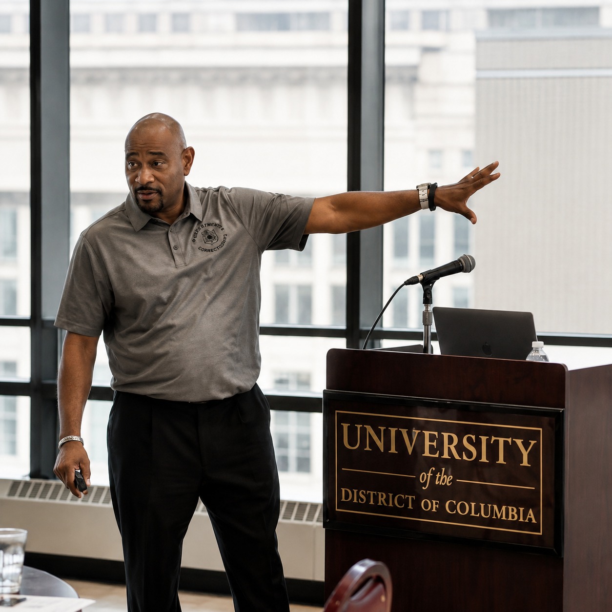 Coach C delivering a keynote from the podium at the University of the District of Columbia